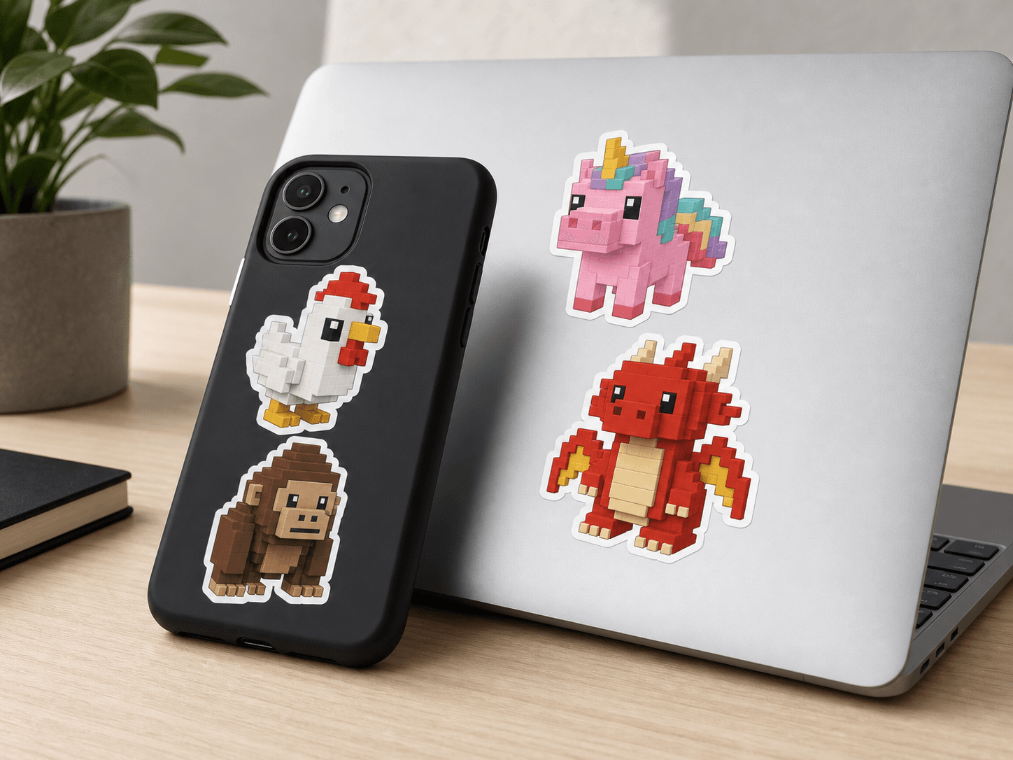 Pixel Pet stickers on a phone case and laptop